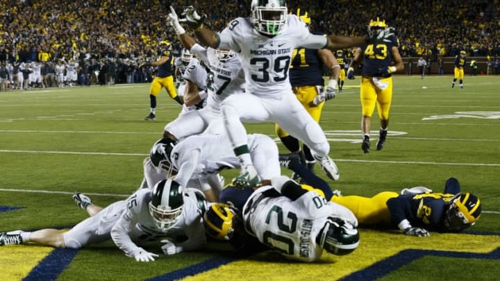 Oct 17, 2015; Ann Arbor, MI, USA; Michigan State Spartans defensive back Jalen Watts-Jackson (20) dives into the end zone for a game winning touchdown as the clock runs out in the fourth quarter against the Michigan Wolverines at Michigan Stadium. Michigan State 27-23. Mandatory Credit: Rick Osentoski-USA TODAY Sports