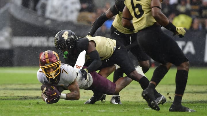 October 2, 2021; West Lafayette, Indiana, USA; Minnesota Golden Gophers wide receiver Chris Autman-Bell (7) is tackled by Purdue Boilermakers cornerback Dedrick Mackey (1) during the second half at Ross-Ade Stadium. Minnesota wins 20 to 13. Mandatory Credit: Marc Lebryk-USA TODAY Sports