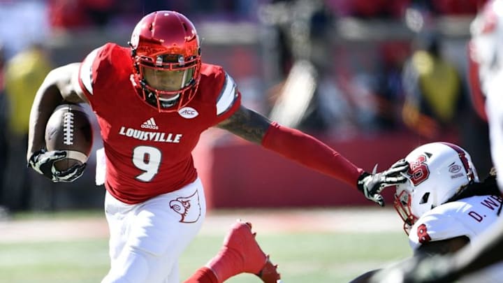Oct 22, 2016; Louisville, KY, USA; Louisville Cardinals wide receiver Jaylen Smith (9) avoids the tackle of North Carolina State Wolfpack defensive back Dravious Wright (8) during the first quarter at Papa John Oct 22, 2016; Louisville, KY, USA; Louisville Cardinals wide receiver Jaylen Smith (9) avoids the tackle of North Carolina State Wolfpack defensive back Dravious Wright (8) during the first quarter at Papa John