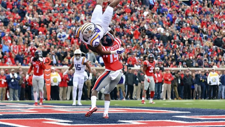 Nov 21, 2015; Oxford, MS, USA; LSU Tigers wide receiver Travin Dural (83) is hit by Mississippi Rebels defensive back Kendarius Webster (15) after an incomplete pass during the first quarter of the game at Vaught-Hemingway Stadium. Dural was injured on this play and left the game. Mandatory Credit: Matt Bush-USA TODAY Sports