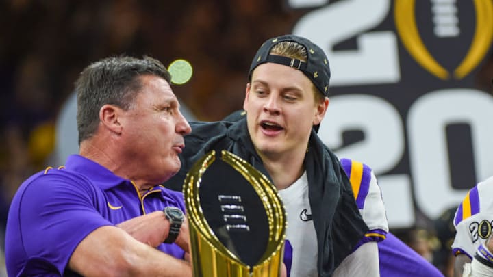 NEW ORLEANS, LA - JANUARY 13: LSU Tigers quarterback Joe Burrow (9) and LSU Tigers head coach Ed Orgeron share a moment on stage before the trophy presentation after winning the CFP National Championship game between the LSU Tigers and Clemson Tigers at the Mercedes-Benz Superdome on January 13, 2020 in New Orleans, LA. (Photo by Ken Murray/Icon Sportswire via Getty Images)