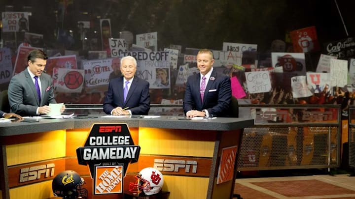 Oct 10, 2015; Salt Lake City, UT, USA; Utah Utes fans hold up signs behind ESPN College Game Day hosts (L-R) Rece Davis and Lee Corso and Kirk Herbstreit during the broadcast at Presidents Circle on the University of Utah campus prior to the game between the California Golden Bears and the Utah Utes. Mandatory Credit: Russ Isabella-USA TODAY Sports