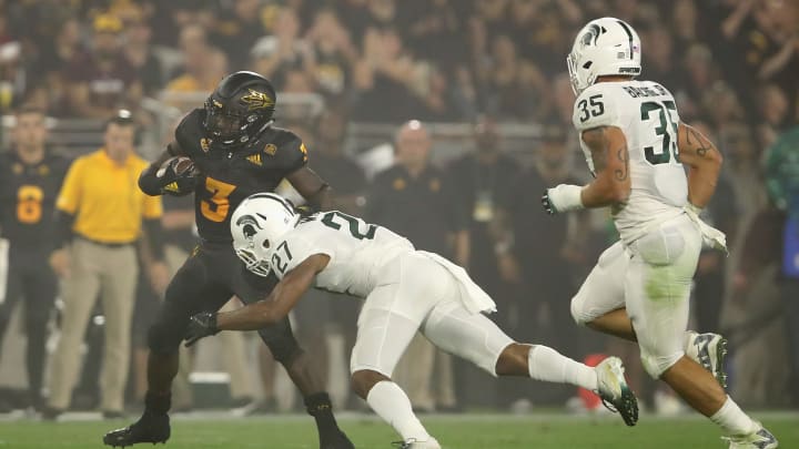 TEMPE, AZ – SEPTEMBER 08: Running back Eno Benjamin #3 of the Arizona State Sun Devils rushes the football past safety Khari Willis #27 of the Michigan State Spartans during the college football game at Sun Devil Stadium on September 8, 2018 in Tempe, Arizona. The Sun Devils defeated the Spartans 16-13. (Photo by Christian Petersen/Getty Images)