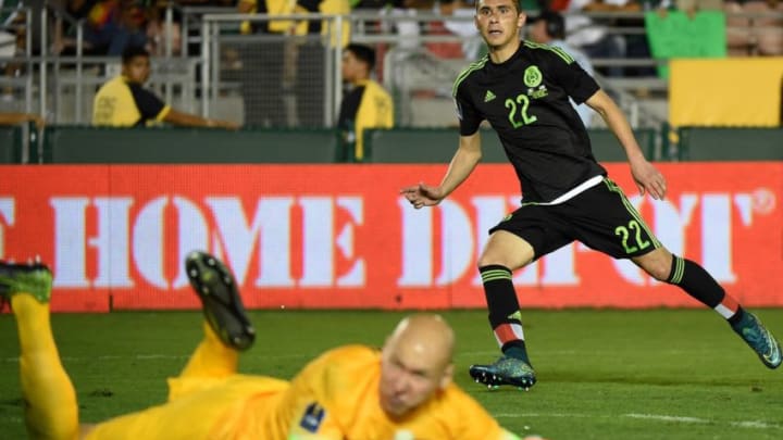 Paul Aguilar of Mexico watches his game winning shot on goal as US goalkeeper Brad Guzan looks on during their 2015 CONCACAF Cup match at the Rose Bowl in Pasadena, California on October 10, 2015. The match is a playoff for the 2017 Confederations Cup. The United States lost to Mexico 3-2. AFP PHOTO / MARK RALSTON (Photo credit should read MARK RALSTON/AFP/Getty Images)