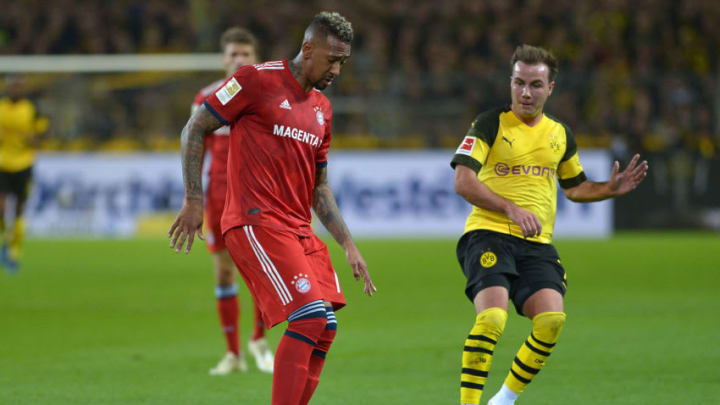 DORTMUND, GERMANY - NOVEMBER 10: Jerome Boateng of Bayern Muenchen and Mario Goetze of Borussia Dortmund battle for the ball during the Bundesliga match between Borussia Dortmund and FC Bayern Muenchen at Signal Iduna Park on November 10, 2018 in Dortmund, Germany. (Photo by TF-Images/Getty Images)