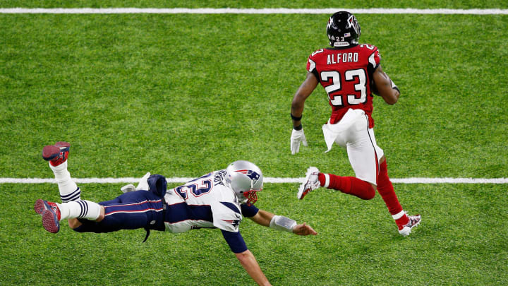 HOUSTON, TX – FEBRUARY 05: Robert Alford #23 of the Atlanta Falcons runs past Tom Brady #12 of the New England Patriots on his way to scoring a touchdown on an 82-yard interception return against the New England Patriots in the second quarter of Super Bowl 51 at NRG Stadium on February 5, 2017 in Houston, Texas. (Photo by Bob Levey/Getty Images)
