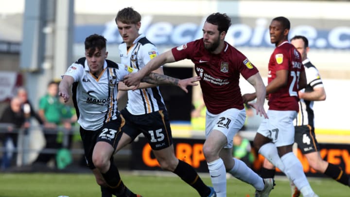 NORTHAMPTON, ENGLAND - MARCH 30: John-Joe O'Toole of Northampton Town contests the ball with Mitchell Clark of Port Vale during the Sky Bet League Two match between Northampton Town and Port Vale at PTS Academy Stadium on March 30, 2019 in Northampton, United Kingdom. (Photo by Pete Norton/Getty Images)