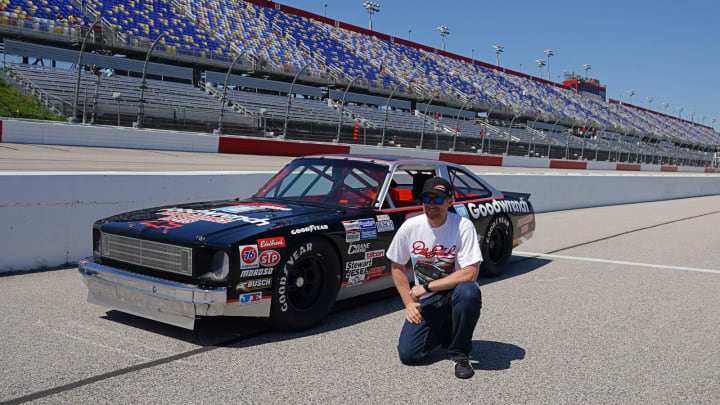 May 8, 2021; Darlington, SC, USA; Former NASCAR driver Dale Earnhardt Jr. poses for a picture with the restored 1984 Chevy Nova driven by his father the late Dale Earnhardt Sr. on pit road prior to the Steakhouse Elite 200 at Darlington Raceway. Mandatory Credit: Jasen Vinlove-USA TODAY Sports