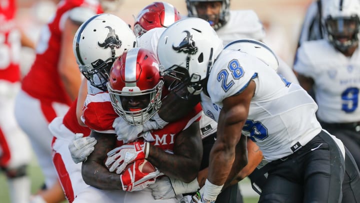 OXFORD, OH – OCTOBER 21: The Buffalo Bulls defense tackles Alonzo Smith #26 of the Miami Ohio Redhawks during the second half at Yager Stadium on October 21, 2017 in Oxford, Ohio. (Photo by Michael Reaves/Getty Images)
