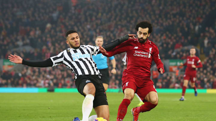 LIVERPOOL, ENGLAND - DECEMBER 26: Mohamed Salah of Liverpool is challenged by Jamaal Lascelles of Newcastle United during the Premier League match between Liverpool FC and Newcastle United at Anfield on December 26, 2018 in Liverpool, United Kingdom. (Photo by Jan Kruger/Getty Images)