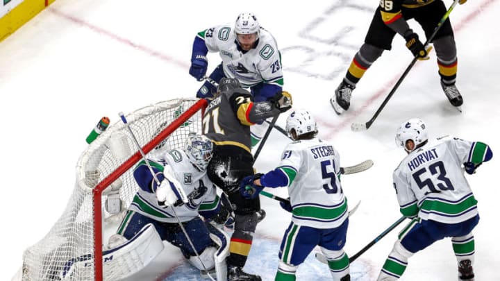 William Karlsson #71 of the Vegas Golden Knights collides with Jacob Markstrom #25 of the Vancouver Canucks during the second period in Game Two of the Western Conference Second Round. (Photo by Bruce Bennett/Getty Images)