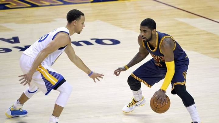 Feb 26, 2015; Cleveland, OH, USA; Cleveland Cavaliers guard Kyrie Irving (2) dribbles against Golden State Warriors guard Stephen Curry (30) in the fourth quarter at Quicken Loans Arena. Mandatory Credit: David Richard-USA TODAY Sports
