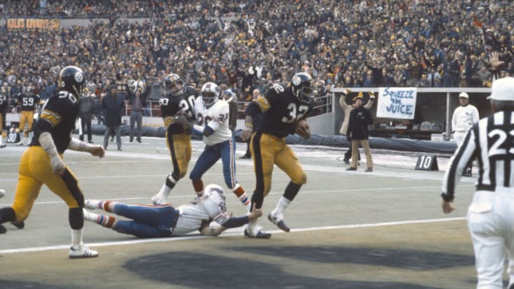 PITTSBURGH, PA - DECEMBER 22: Running back Franco Harris #32 of the Pittsburgh Steelers scores a touchdown against the Buffalo Bills during the AFC Divisional Playoffs December 22, 1974 at Three Rivers Stadium in Pittsburgh, Pennsylvania. Harris played for the Steelers from 1972-83. (Photo by Focus on Sport/Getty Images)