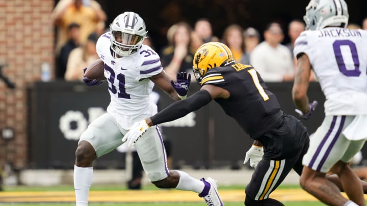 Sep 16, 2023; Columbia, Missouri, USA; Kansas State Wildcats running back DJ Giddens (31) runs the ball against Missouri Tigers defensive back Jaylon Carlies (1) during the first half at Faurot Field at Memorial Stadium. Mandatory Credit: Jay Biggerstaff-USA TODAY Sports