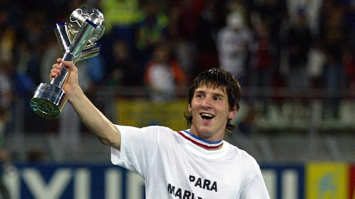 Argentina's Lionel Messi holds the troph