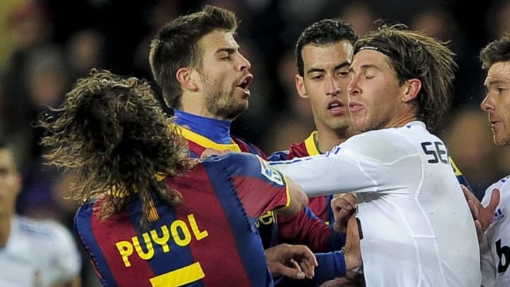 Barcelona's captain Carles Puyol (L) rea Barcelona's captain Carles Puyol (L) rea