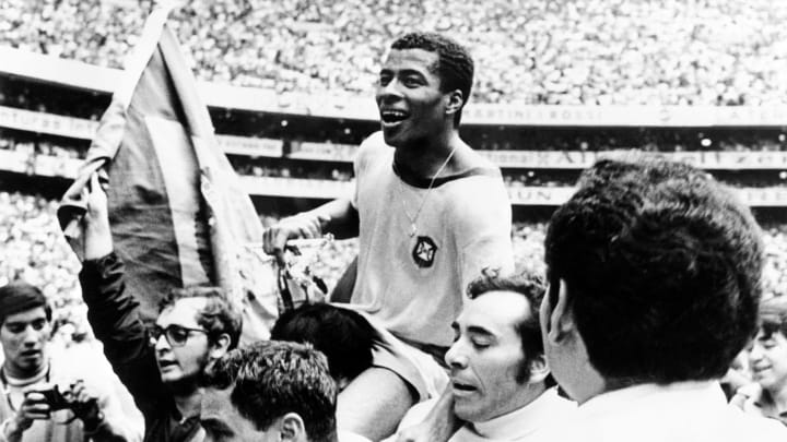 Brazilian forward Jairzinho is carried by fans aft