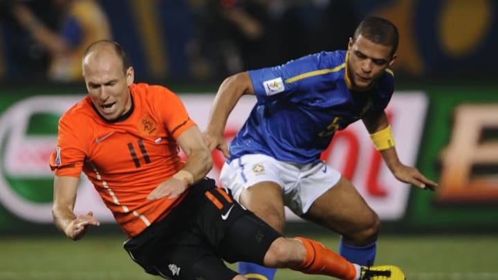 Brazil's midfielder Felipe Melo (R) tack