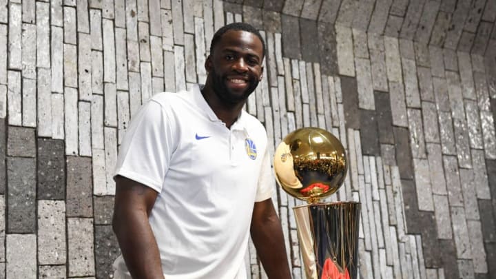 Golden State Warriors player Draymond Green with the Larry O'Brien Trophy