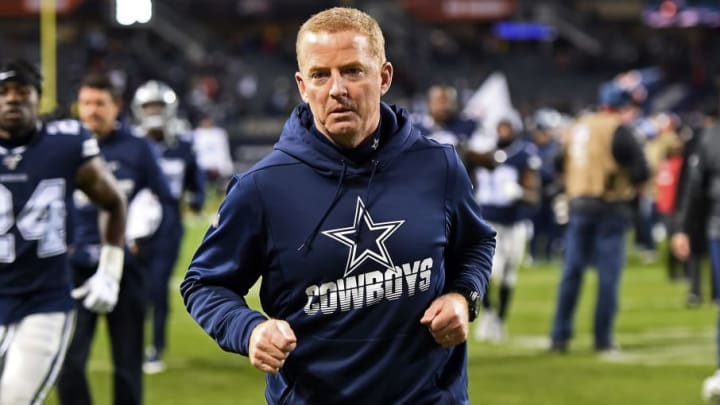Jason Garrett walks off the field at halftime of the Cowboys game.