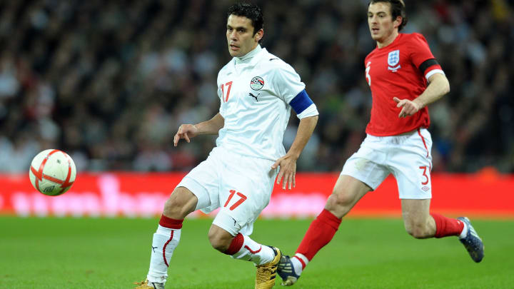 Egypt's Ahmed Hassan (L) curls the ball