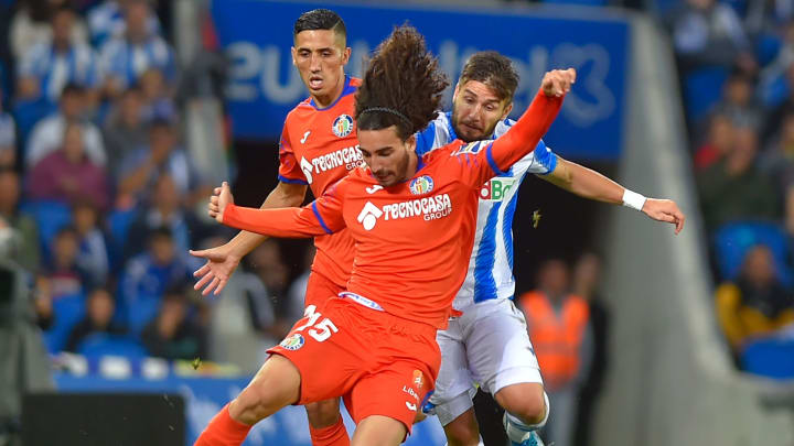 Marc Cucurella (Getafe) and Cristian Portugués "Portu" (Real Sociedad) fighting for the ball.