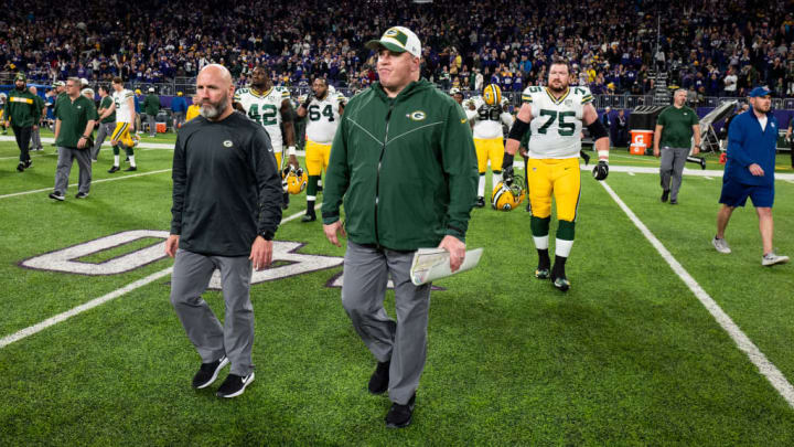 Mike McCarthy walks onto the field after a game against the Minnesota Vikings