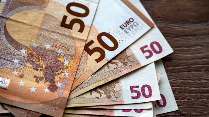In this photo illustration, a collection of fifty Euro... In this photo illustration, a collection of fifty Euro...