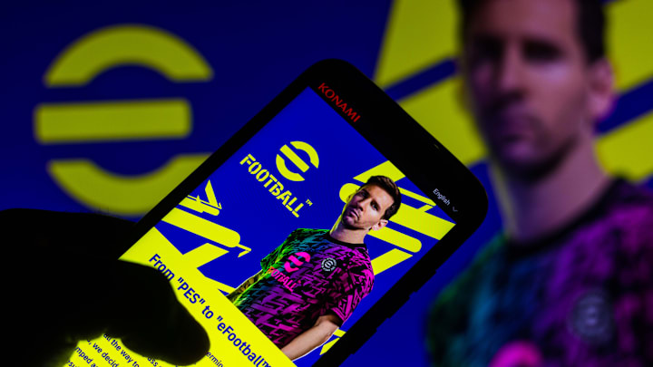 Messi é um dos embaixadores do game | In this photo illustration, eFootball logo game with... Messi é um dos embaixadores do game | In this photo illustration, eFootball logo game with...