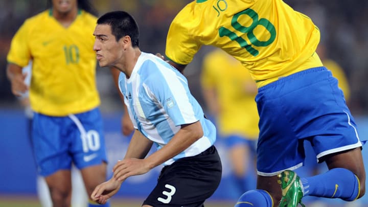Jo of Brazil (R) challenges Luciano Monz