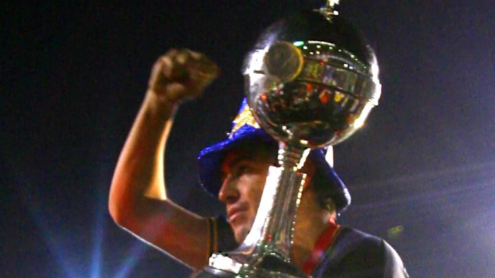 Juan Roman Riquelme of Boca Juniors hold...