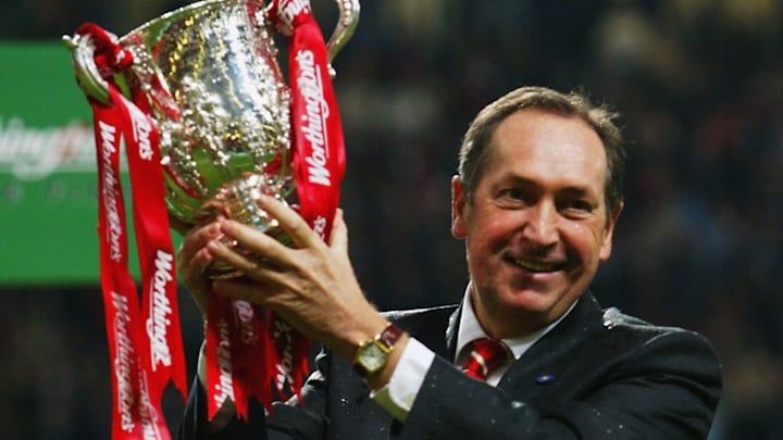 Liverpool manager Gerard Houllier poses with the trophy