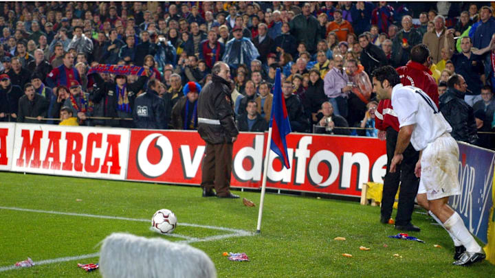 Luis Figo of Real Madrid is bombarded by missiles