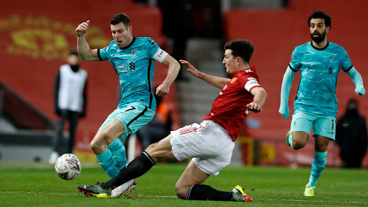 James Milner kala berduel merebutkan bola dengan Harry Maguire