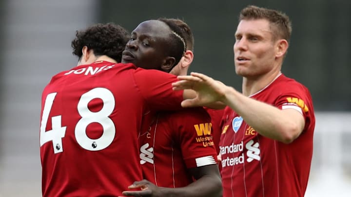 Sadio Mane celebrates with Curtis Jones, James Milner, and Andy Robertson's ear