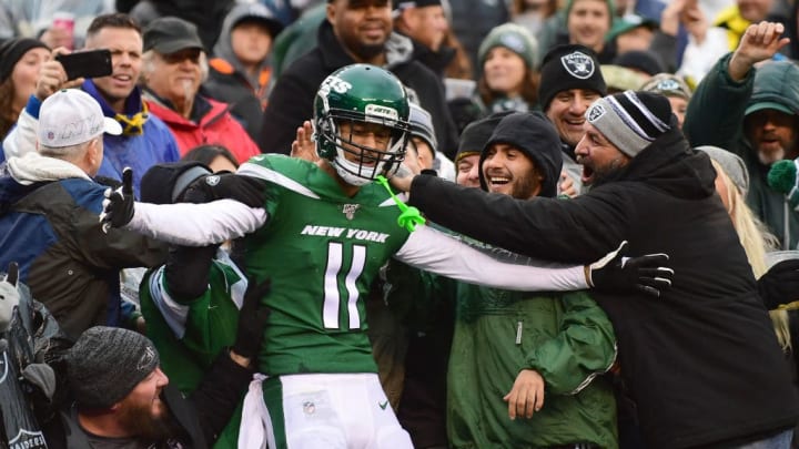 Robby Anderson celebrates with fans behind the end zone after a receiving touchdown.