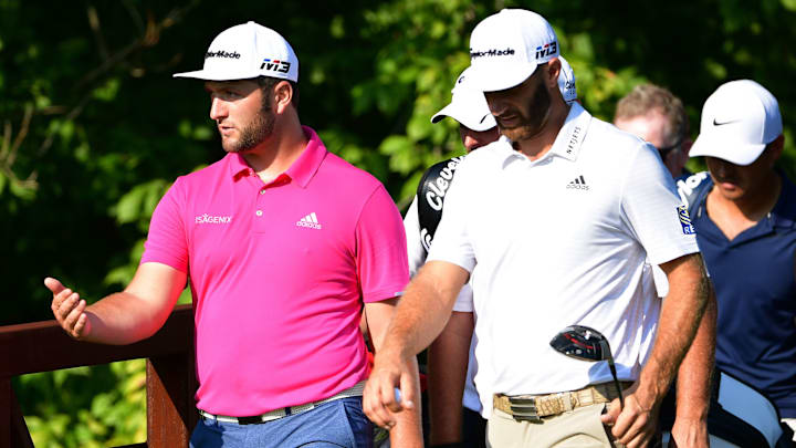 Jon Rahm and Dustin Johnson walking off the tee. Jon Rahm and Dustin Johnson walking off the tee.
