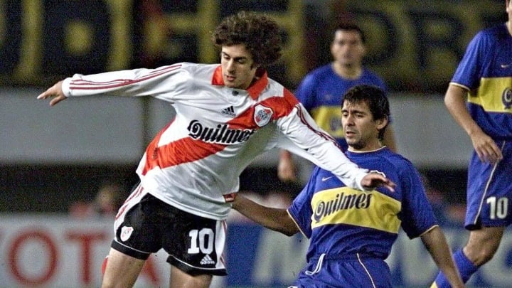 Pablo Aimar (L) of River Plate takes the ball from