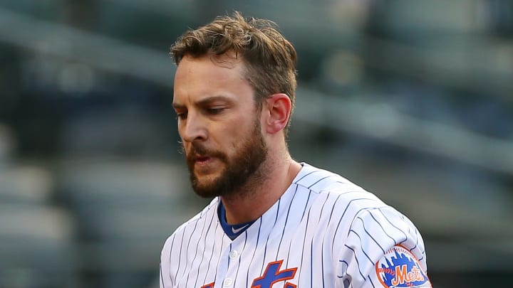New York mets infielder Jed Lowrie walks toward the dugout against the Philadelphia Phillies
