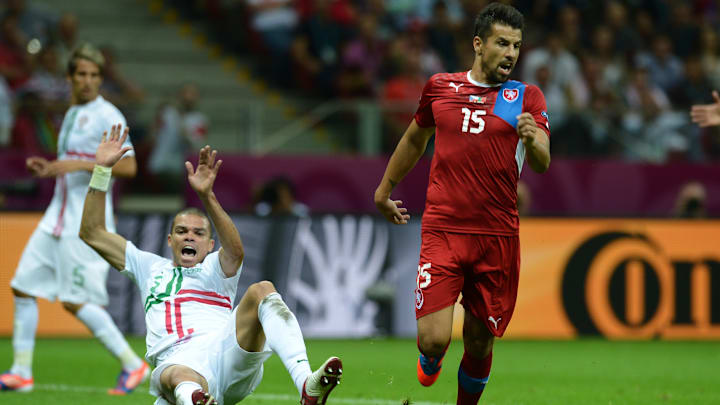 Portuguese defender Pepe (L) falls next 