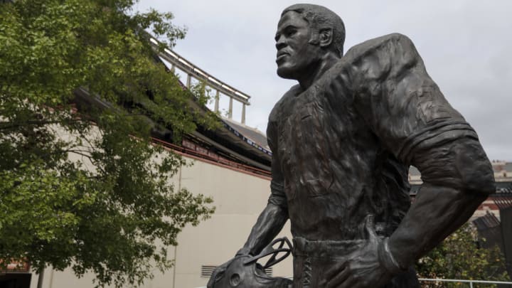 This University of Texas statue is in honor of a legendary Longhorns running back, who also tops this list of NFL greats.