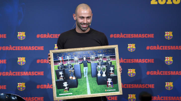 Javier Mascherano is presented with a photo of himself with his trophy haul at Barcelona before he left the club