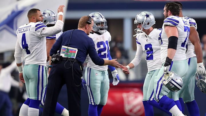 ARLINGTON, TEXAS - DECEMBER 23: Dak Prescott #4, Ezekiel Elliott #21 and head coach Jason Garrett celebrate the 59 yard field goal by Brett Maher #2 of the Dallas Cowboys in the third quarter against the Tampa Bay Buccaneers at AT&T Stadium on December 23, 2018 in Arlington, Texas. (Photo by Tom Pennington/Getty Images) ARLINGTON, TEXAS - DECEMBER 23: Dak Prescott #4, Ezekiel Elliott #21 and head coach Jason Garrett celebrate the 59 yard field goal by Brett Maher #2 of the Dallas Cowboys in the third quarter against the Tampa Bay Buccaneers at AT&T Stadium on December 23, 2018 in Arlington, Texas. (Photo by Tom Pennington/Getty Images)