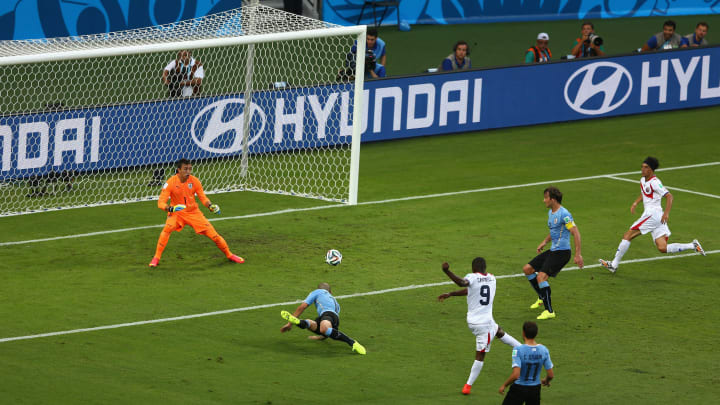 The Uruguayan defence watches Campbell's thunderous volley find the net at the 2014 World Cup