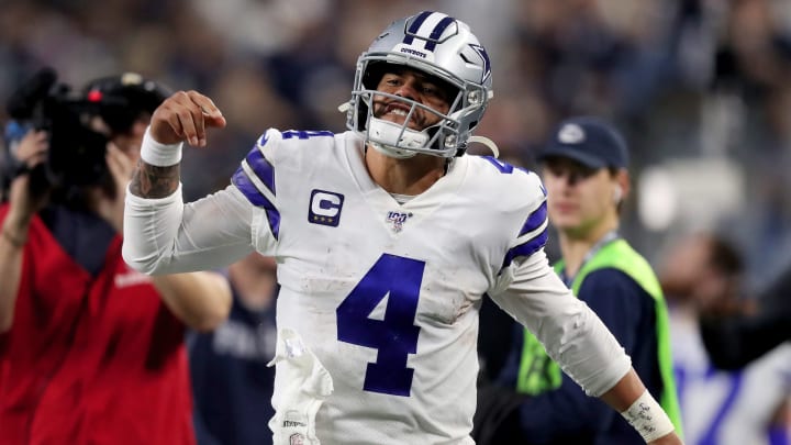 Cowboys quarterback Dak Prescott pumps his fist in celebration during a game against the Redskins.