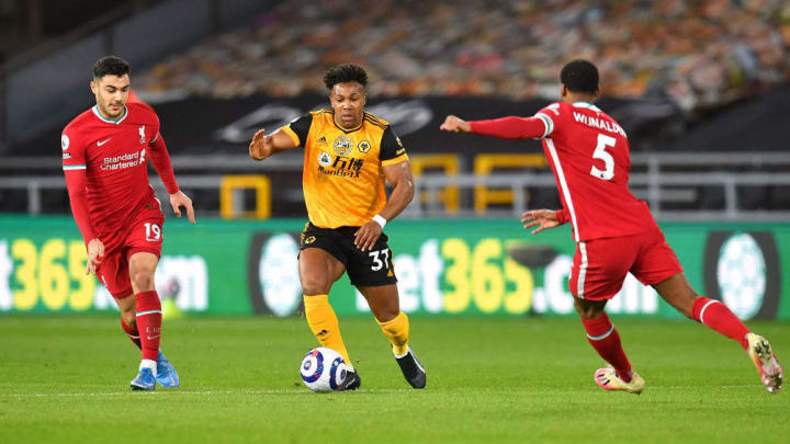 Liverpool's Georginio Wijnaldum challenges Wolves' Adama Traore 