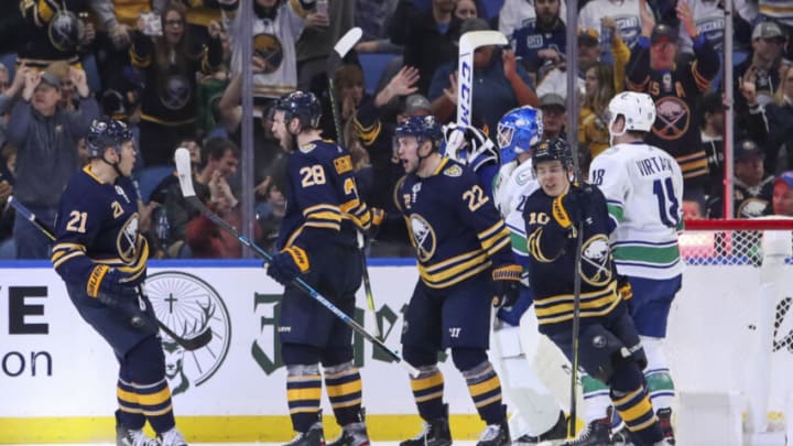 BUFFALO, NY - JANUARY 11: Zemgus Girgensons #28 of the Buffalo Sabres celebrates his game tying goal with Kyle Okposo #21, Johan Larsson #22, and Henri Jokiharju #10. Girgensons goal tied the game at 3-3 with 17:32 remaining in the 3rd period of play the NHL hockey game between the Vancouver Canucks and Buffalo Sabres at KeyBank Center on January 11, 2020 in Buffalo, New York. (Photo by Nicholas T. LoVerde/Getty Images)