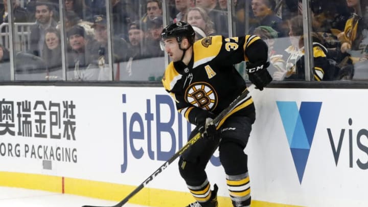 BOSTON, MA - NOVEMBER 21: Boston Bruins center Patrice Bergeron (37) looks for a teammate in front during a game between the Boston Bruins and the Buffalo Sabres on November 21, 2019, at TD Garden in Boston, Massachusetts. (Photo by Fred Kfoury III/Icon Sportswire via Getty Images)
