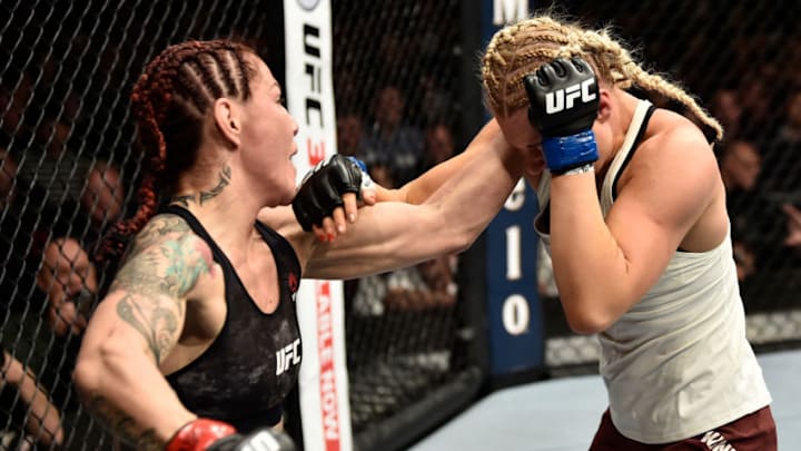 LAS VEGAS, NV - MARCH 03: (L-R) Cris Cyborg of Brazil punches Yana Kunitskaya of Russia in their women's featherweight bout during the UFC 222 event inside T-Mobile Arena on March 3, 2018 in Las Vegas, Nevada. (Photo by Jeff Bottari/Zuffa LLC/Zuffa LLC via Getty Images)