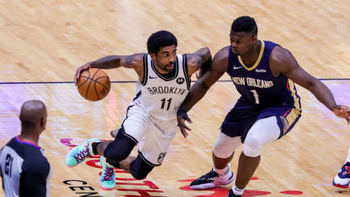 Brooklyn Nets guard Kyrie Irving (11) dribbles against New Orleans Pelicans forward Zion Williamson (1) Credit: Stephen Lew-USA TODAY Sports